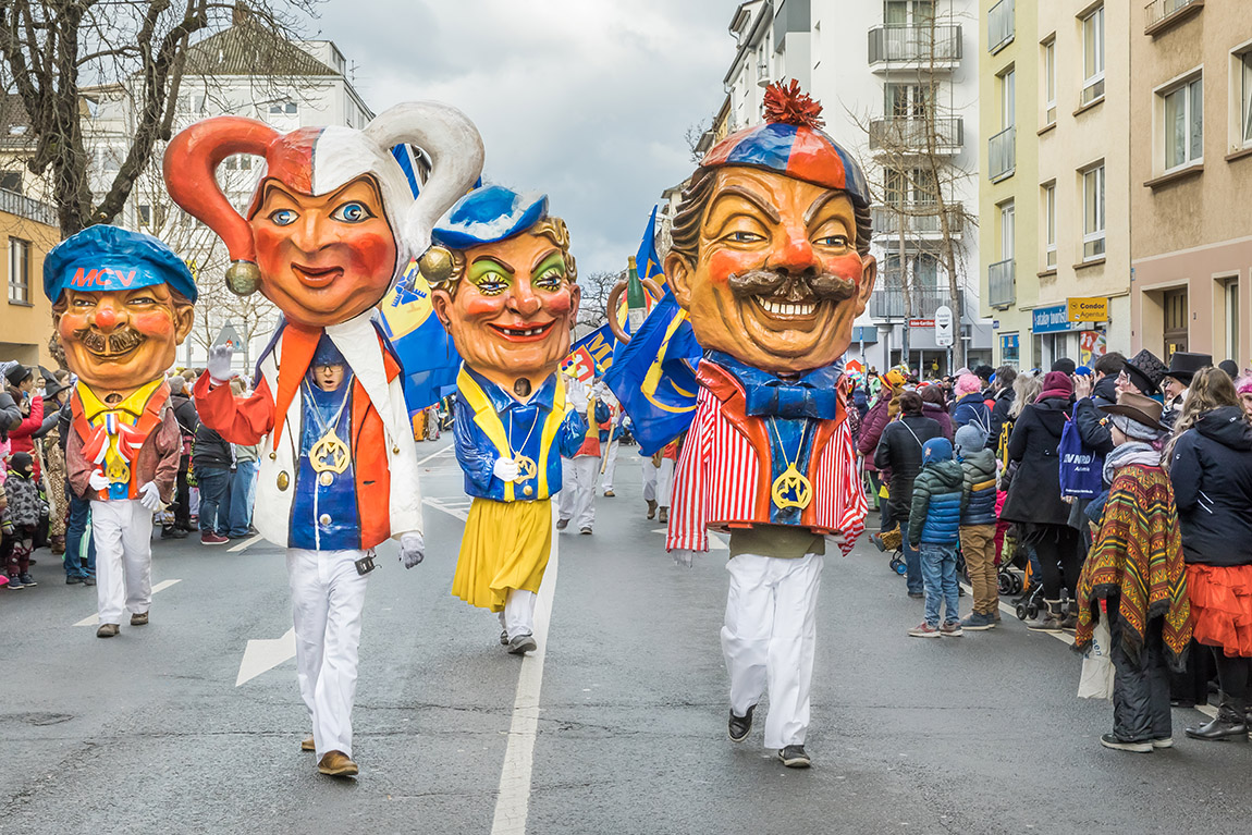 Participants in the Mainz carnival parade wear colourful costumes and large papier-mâché heads. Photo: DZT/Dietmar Scherf | Confetti, Costumes & Culture: Germany’s Top 5 Carnival Events - Your essential guide to some of the best carnival events in Germany