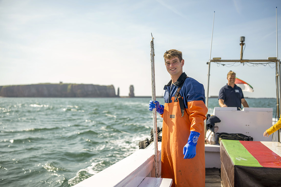 Lobster fishers off Heligoland on a traditional Börteboot. Photo: Till Werner, Helgoland Tourismus-Service | Heligoland: The island with holes in it